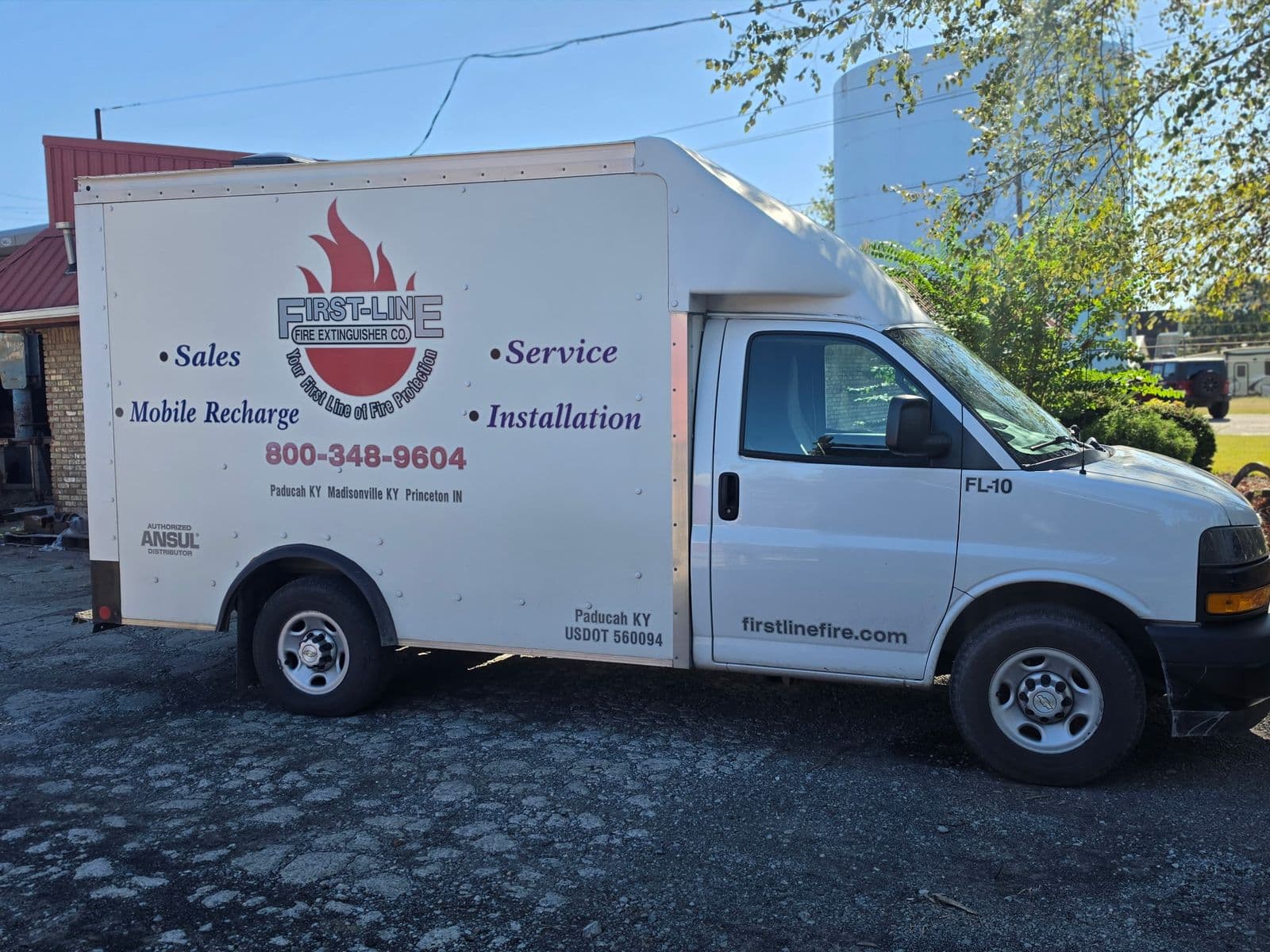White First-Line Fire Extinguisher Co. service truck lettered for sales, service, mobile recharge and installation, with shops in Paducah, Madisonville and Princeton