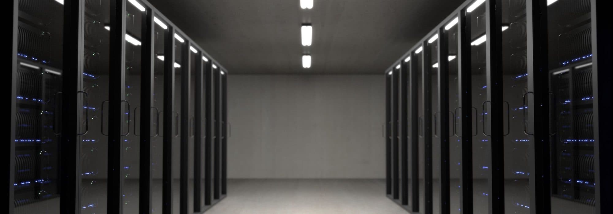 Bright empty server-room aisle with rows of racks — no water on the servers