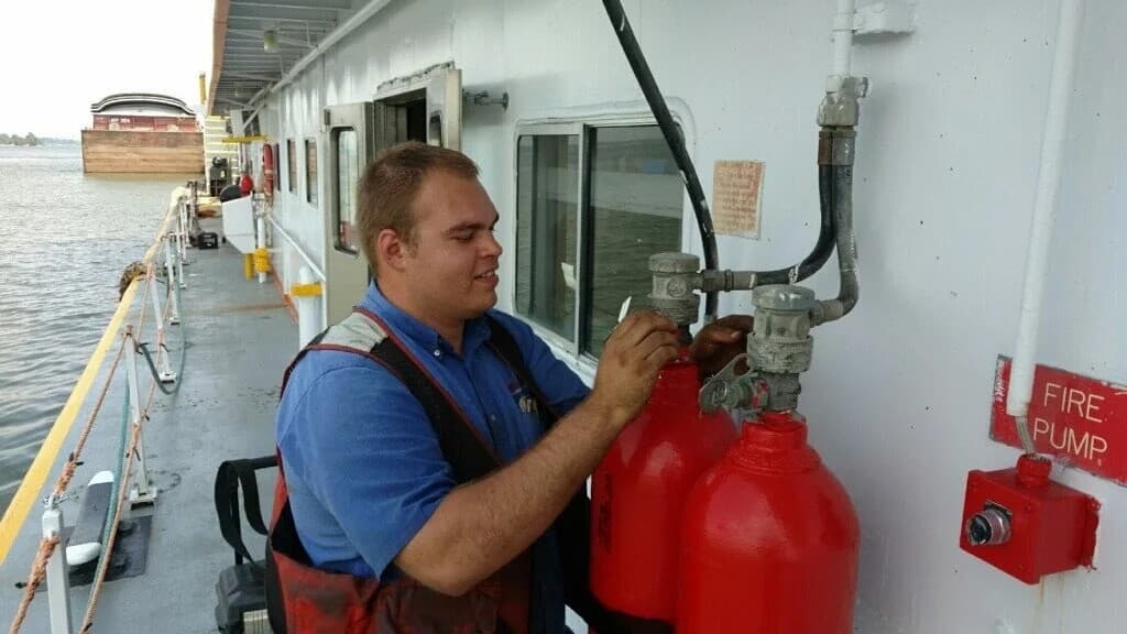 First-Line technician inspecting and servicing suppression on a vessel
